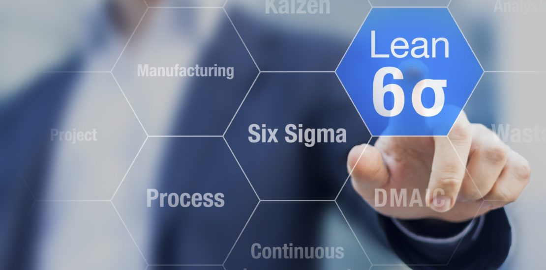 Businessman touching lean six sigma button for improved manufact Businessman touching lean six sigma button for improved manufacturing